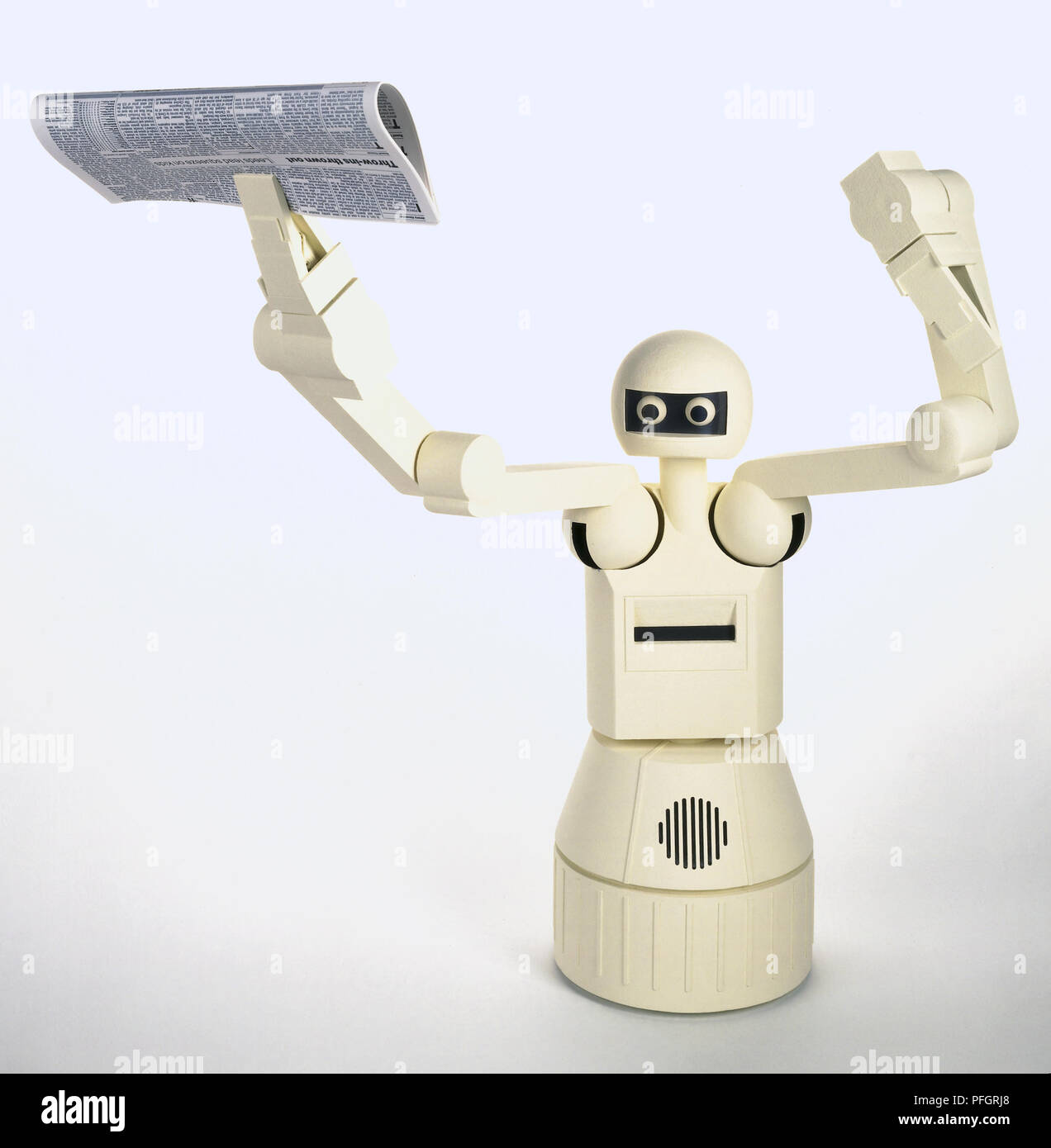 Home-help robot with arms raised and a newspaper in one hand Stock Photo -  Alamy