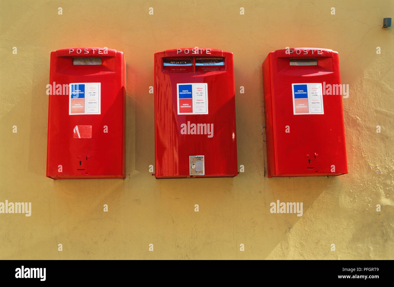 Italy, Tuscany, Portoferraio, Island of Elba, three red mail boxes. Stock Photo