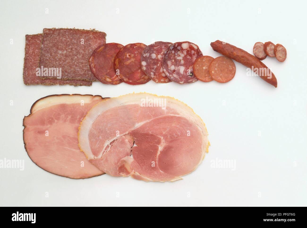 Slices of cooked ham, and different types of salami and cured ...