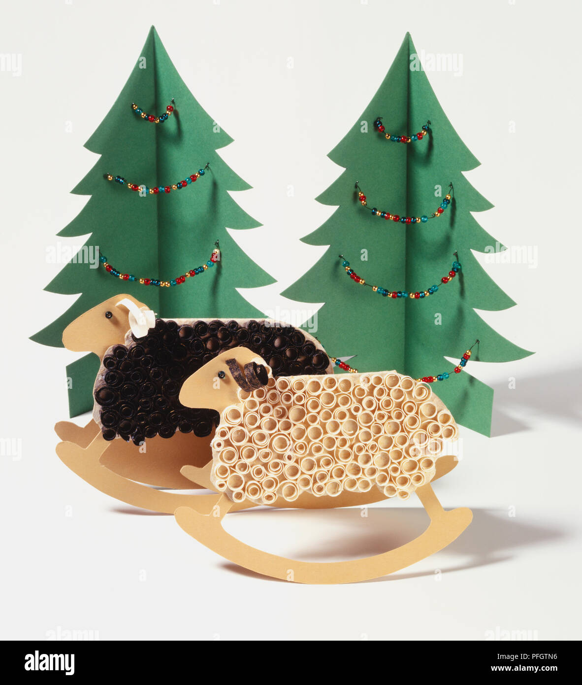 Novelty Christmas Cards Cardboard Sheep With Brown And Cream Curling Ribbon Coats Rocking On Curved Bases Green Card Christmas Trees With Colourful Beaded Garlands Stock Photo Alamy