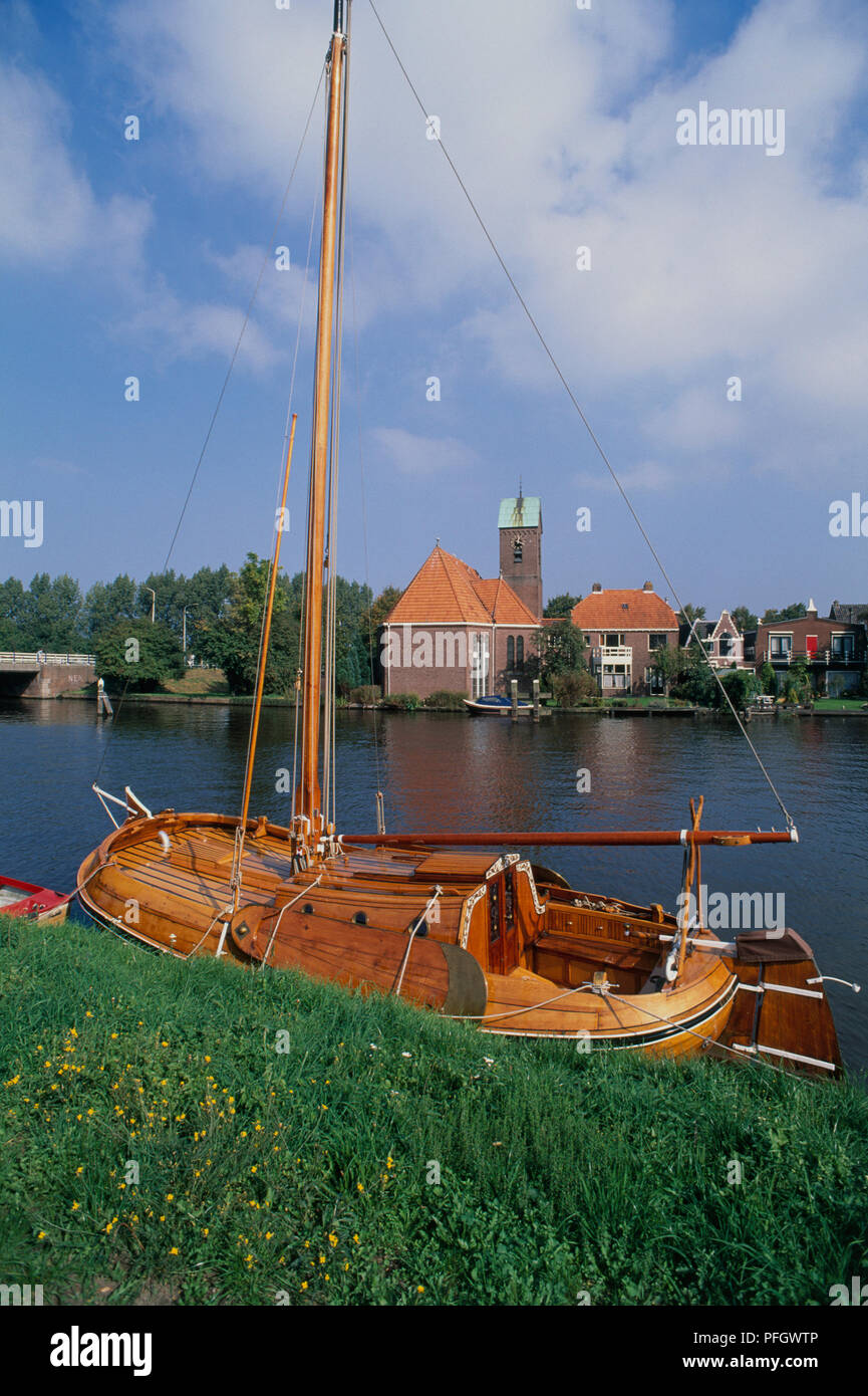 Holland, Amsterdam, moored sailing boat on river at Ouderkerk aan de Amstel. Stock Photo