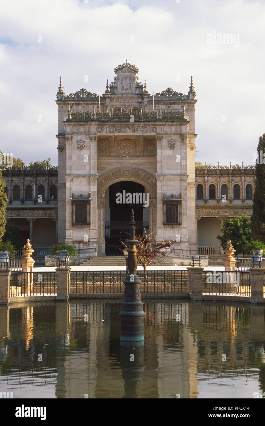 Spain, Seville, Museo Arqueologico, Neo Renaissance acheological museum, reflected in ormnamental pond, Parque Maria Luisa. Stock Photo