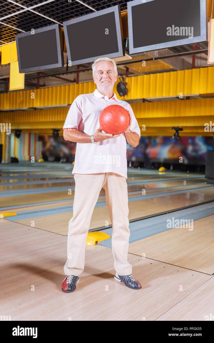 Happy positive man being in the bowling club Stock Photo