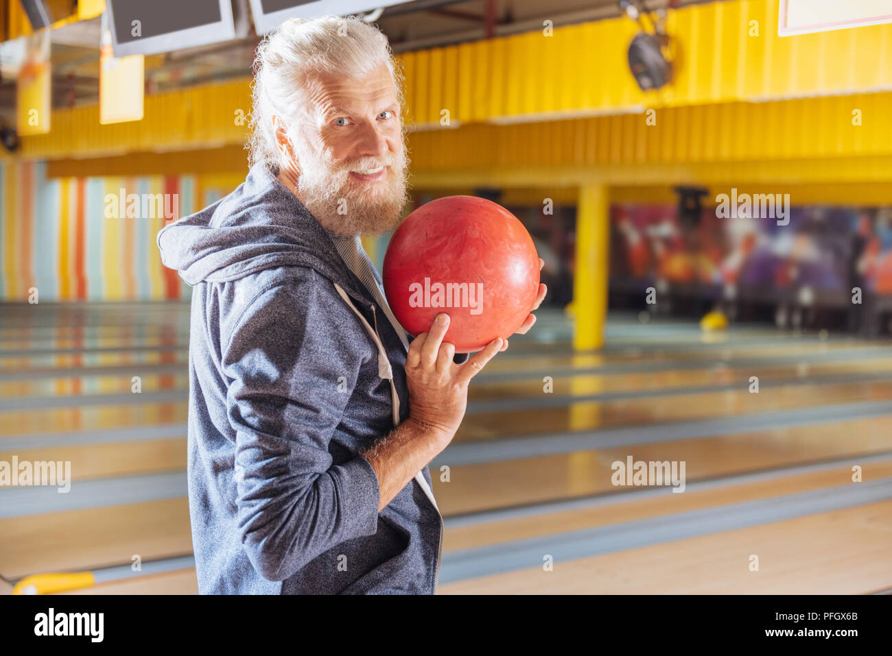 Nice bearded man smiling to you in the bowling club Stock Photo