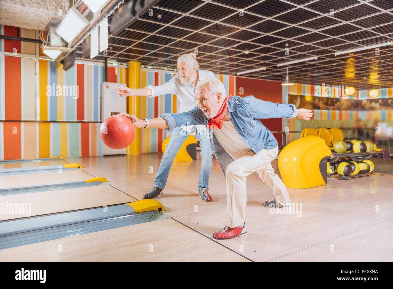 Cheerful nice elderly men having fun together Stock Photo