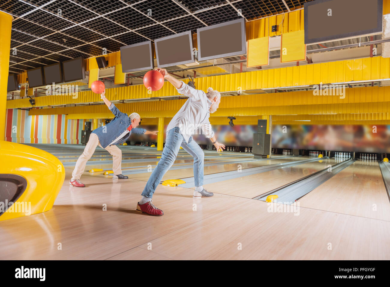 Skilled elderly bowling players throwing the balls Stock Photo