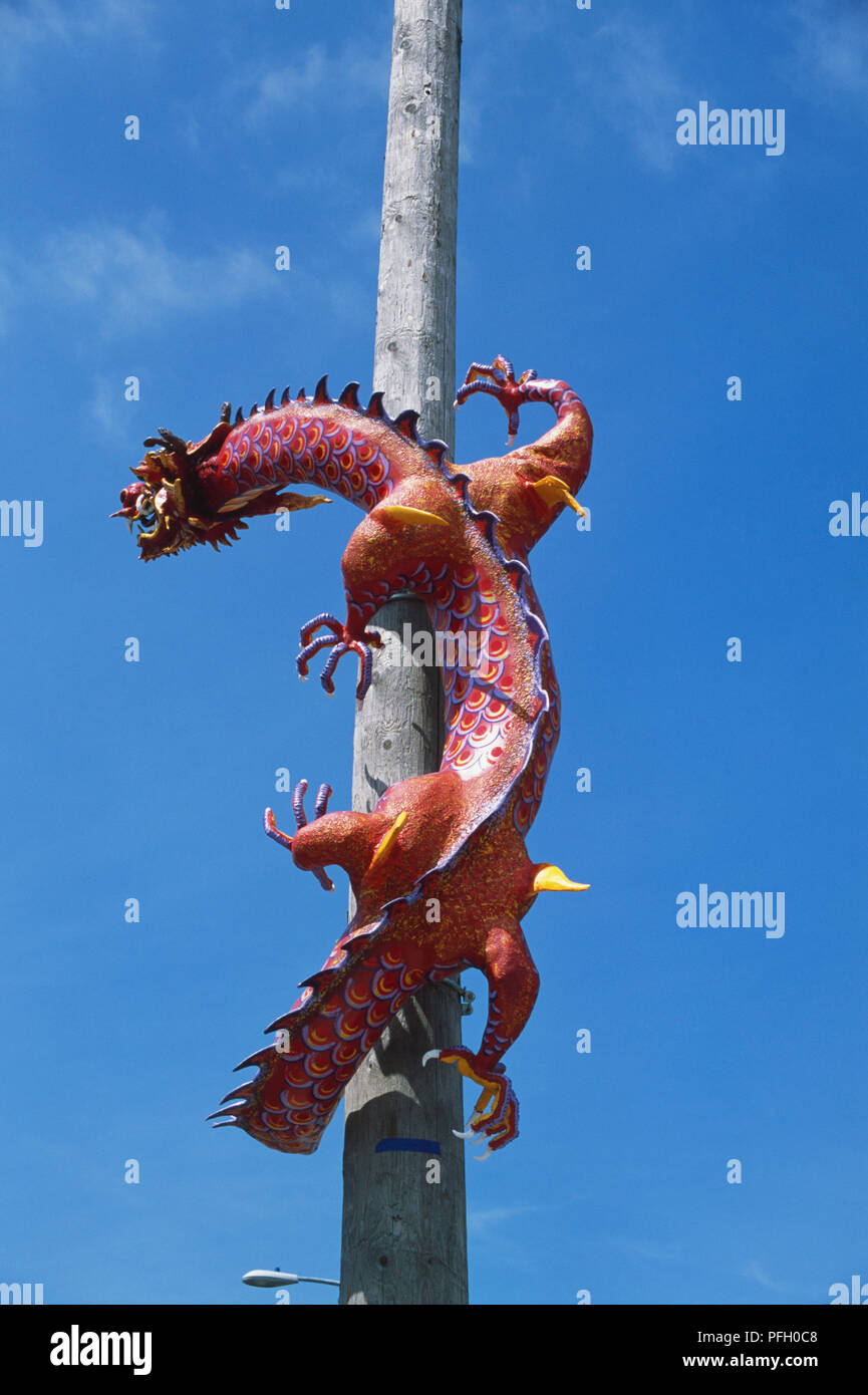 USA, Pacific Northwest, Washington State, Seattle, Pioneer Square, International District, colorful Chinese dragon attached to wooden telegraph pole. Stock Photo