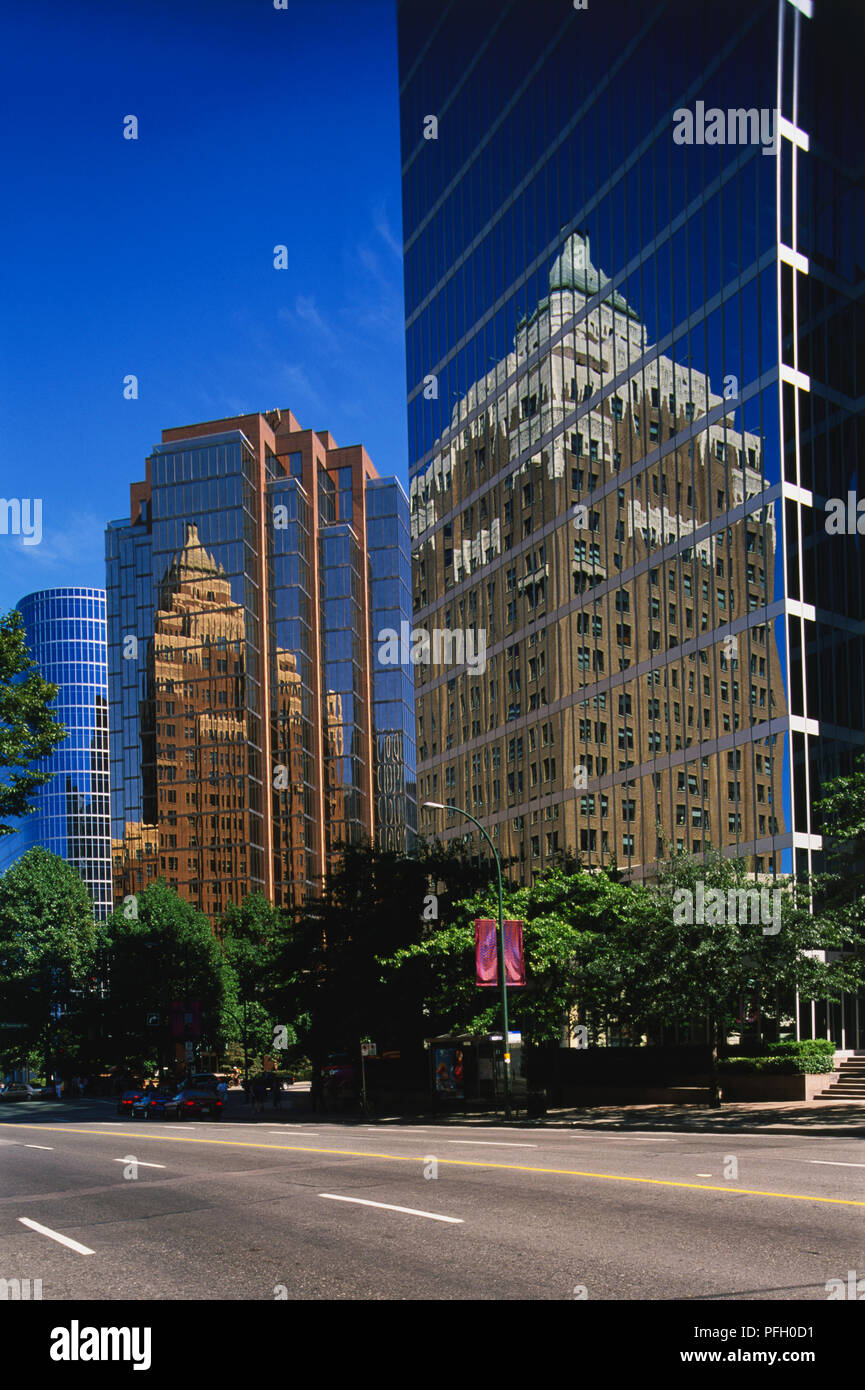 Canada, Pacific Northwest, British Columbia, Vancouver, Downtown, reflections of Art Deco Marine Building on fa ades of glass-fronted high-rise office blocks. Stock Photo