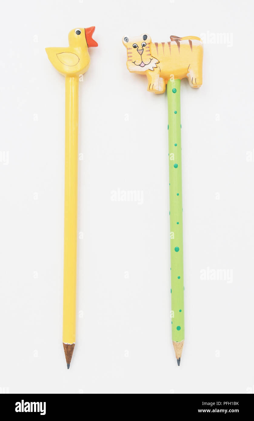 Two pencils with wooden animal figures on the end Stock Photo