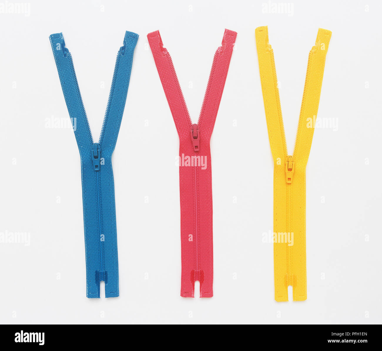 Three zips in a row, partially unzipped Stock Photo Alamy