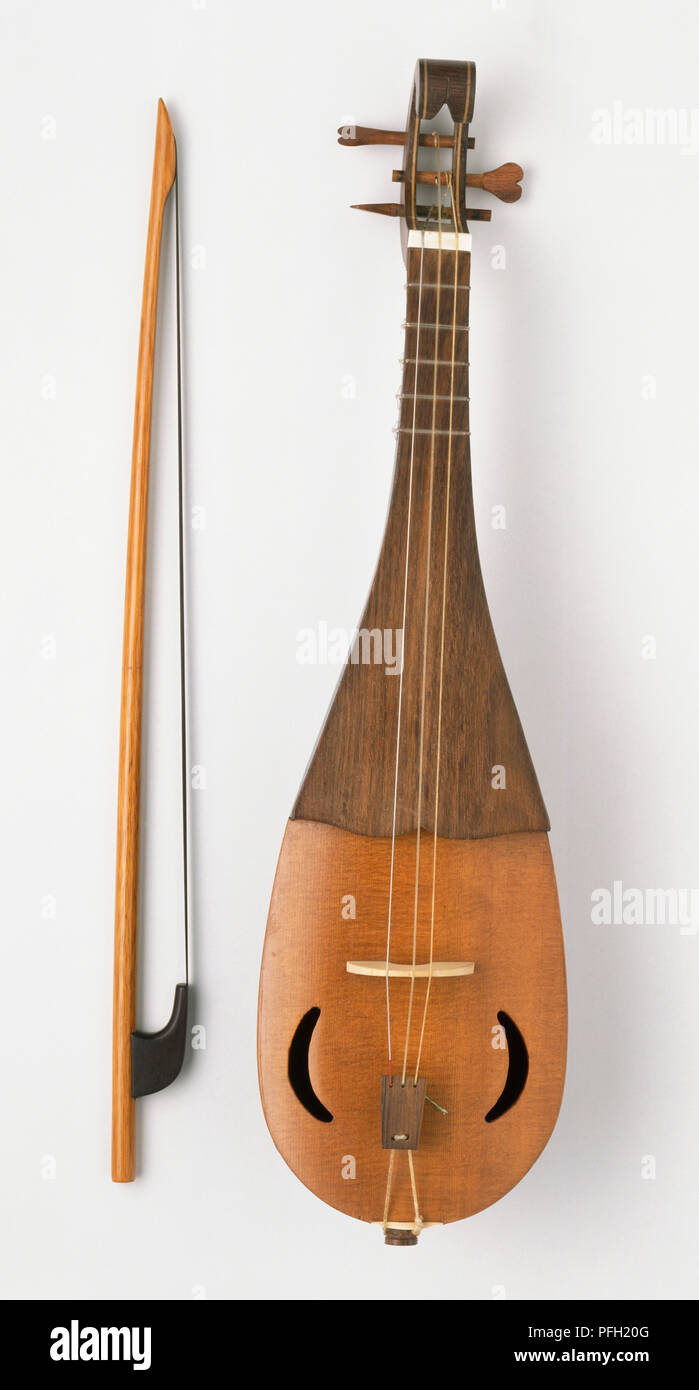 Rebec, medeival pear-shaped stringed instrument, and bow. Stock Photo