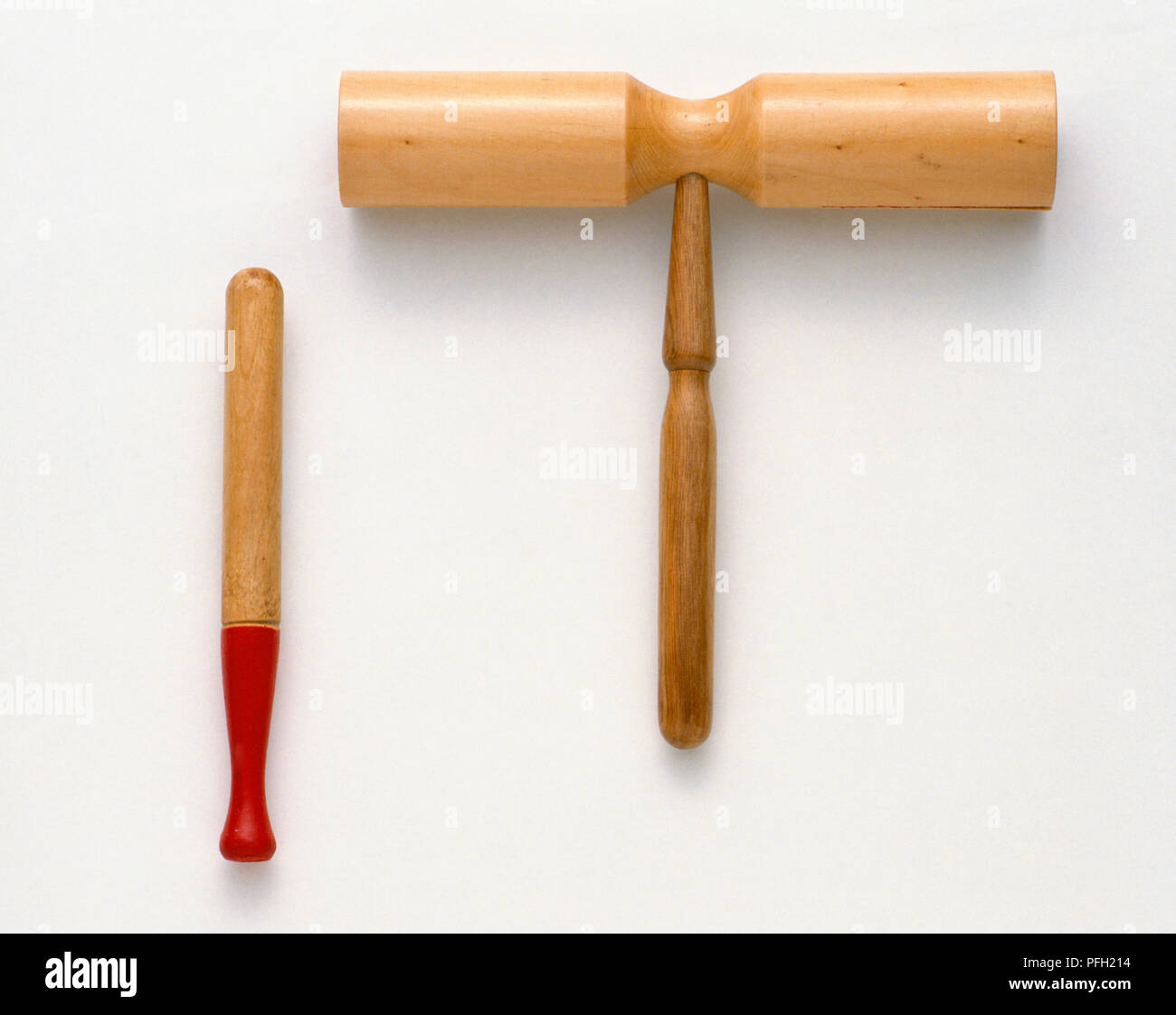 Two-tone block, simple wooden percussion instrument, with beater. Stock Photo