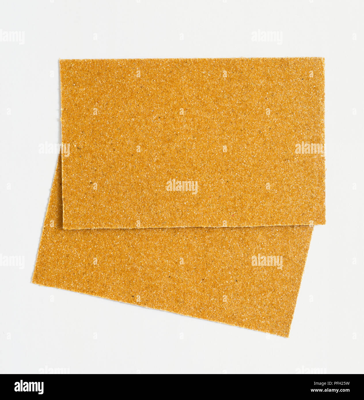 Two pieces of sandpaper, glasspaper, showing rough texture, above view