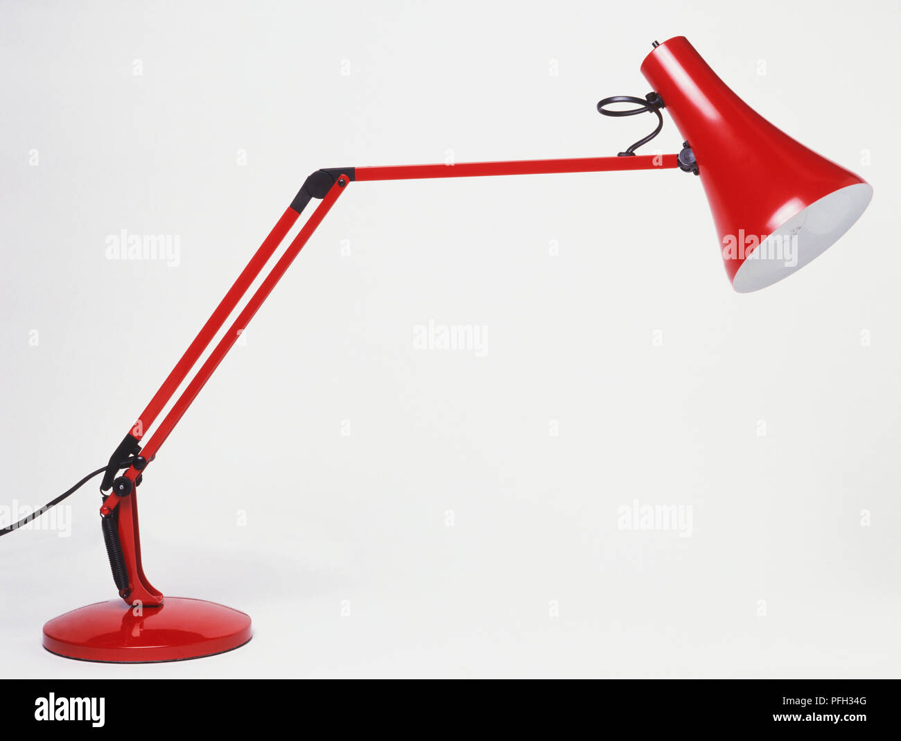 Red metal desk lamp, side view Stock Photo