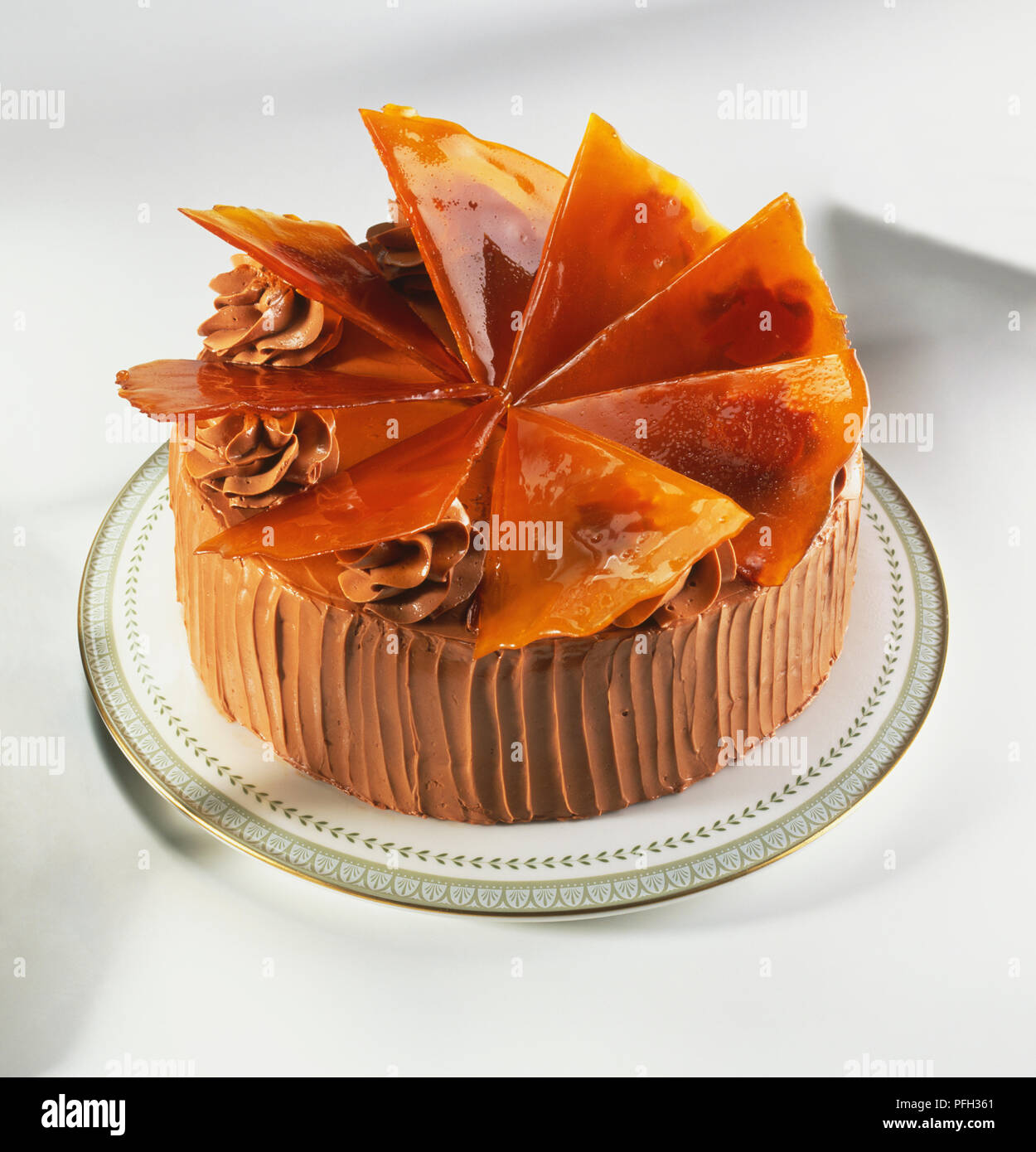 Dobos torta cake, a rich chocolate cream-coated cake topped with sheets of caramel glaze, high angle view Stock Photo