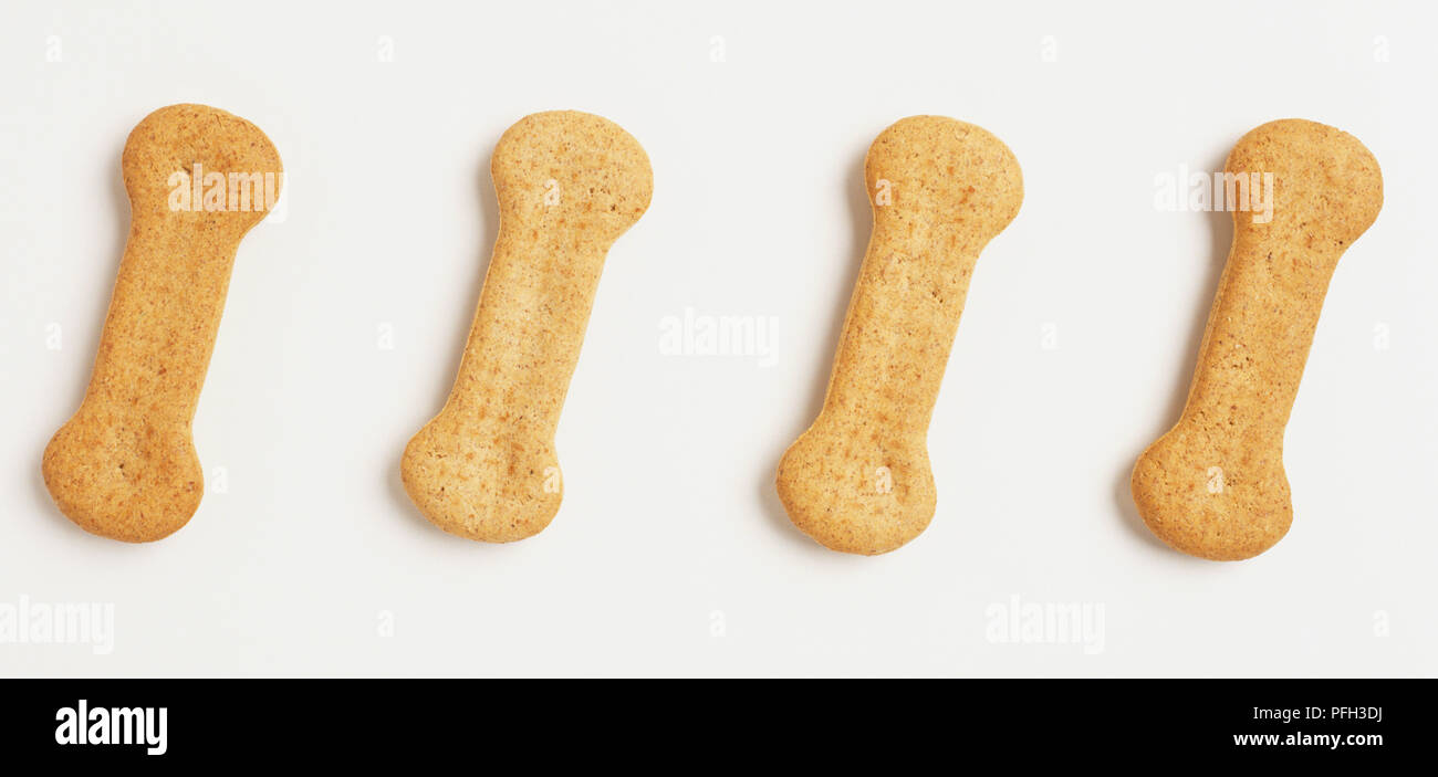 Four boneshaped dog biscuits, close up Stock Photo Alamy