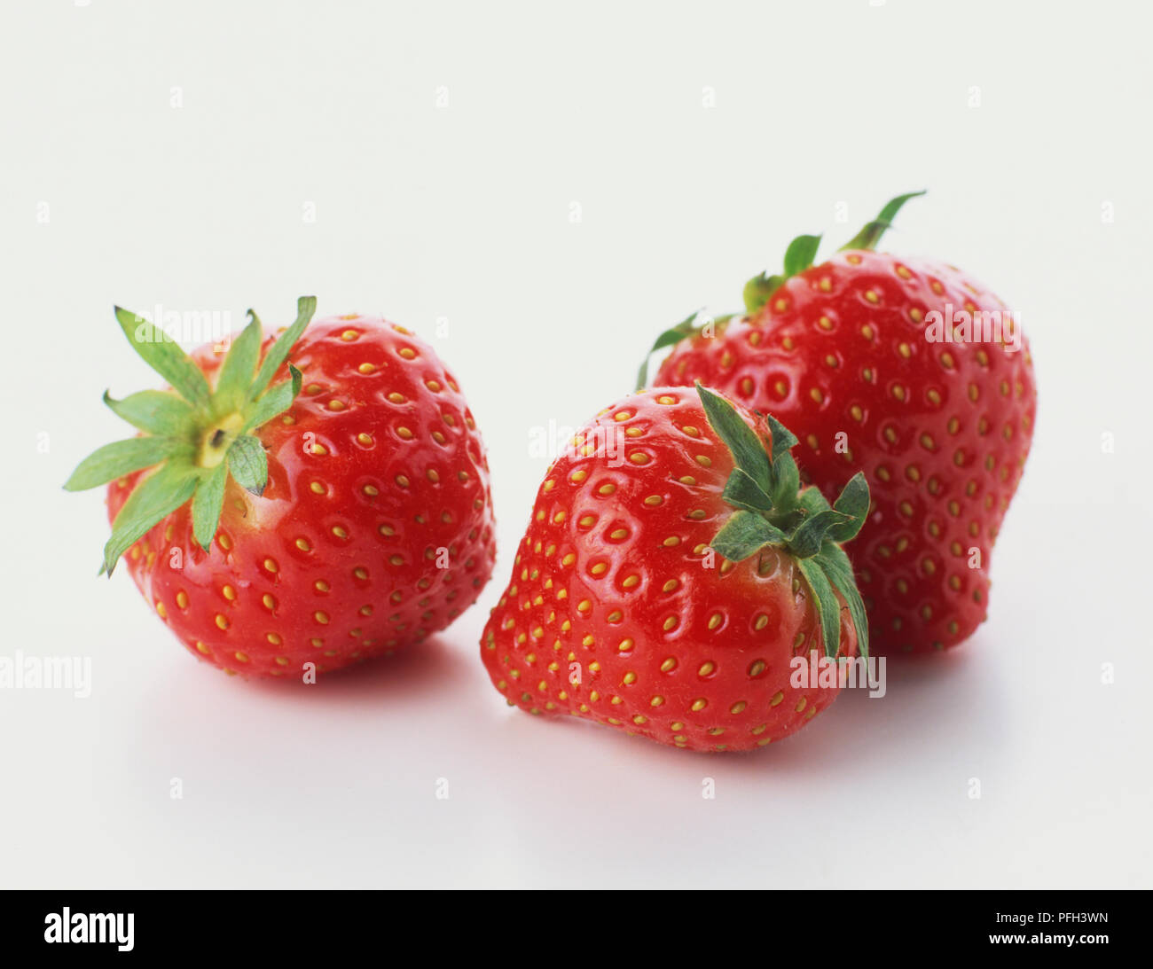 Three fresh strawberries, close up Stock Photo - Alamy