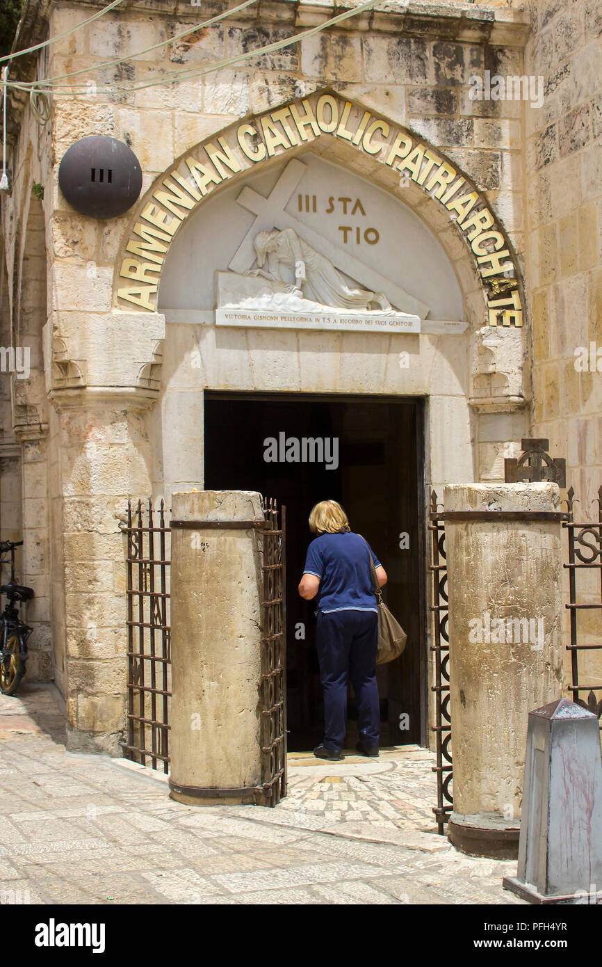 10 May 2018 A lady entering an Armenian church ion the Via Dolorosa in Jerusalem israel Stock Photo
