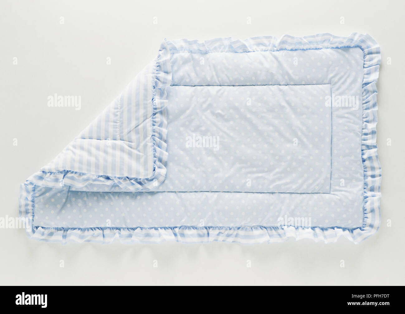 Blue baby blanket with a corner folded back Stock Photo
