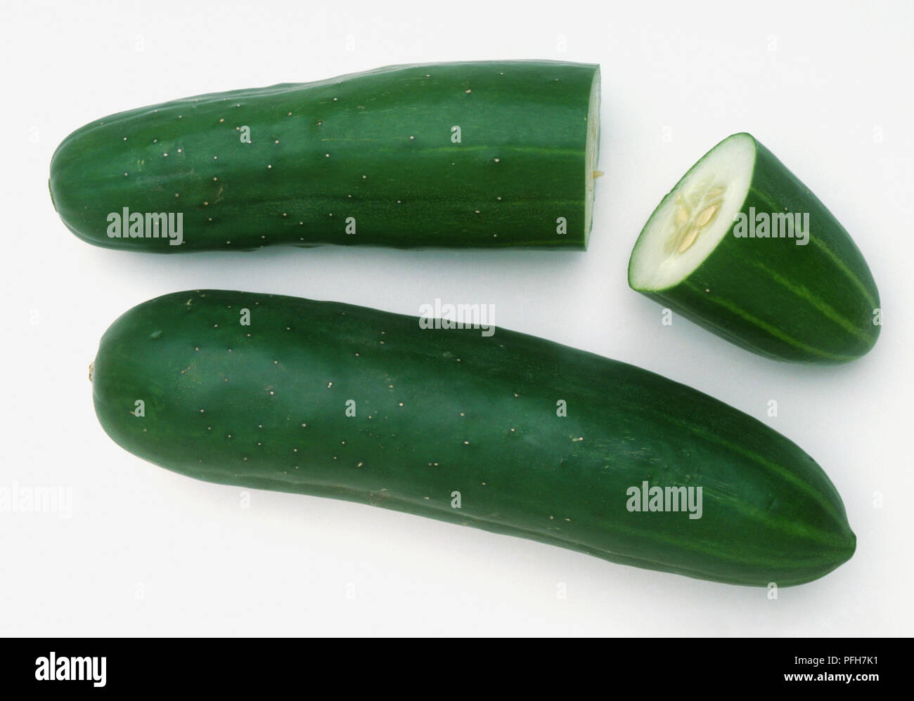 Cucumis sativius, two short, thick Cucumbers, top end cut away Stock Photo