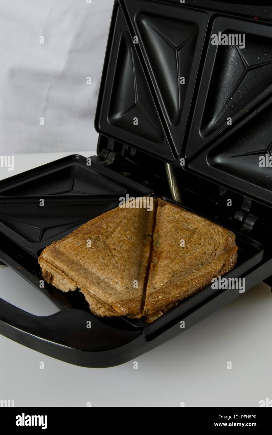 Toasted sandwiches in sandwich maker, closeup Stock Photo Alamy
