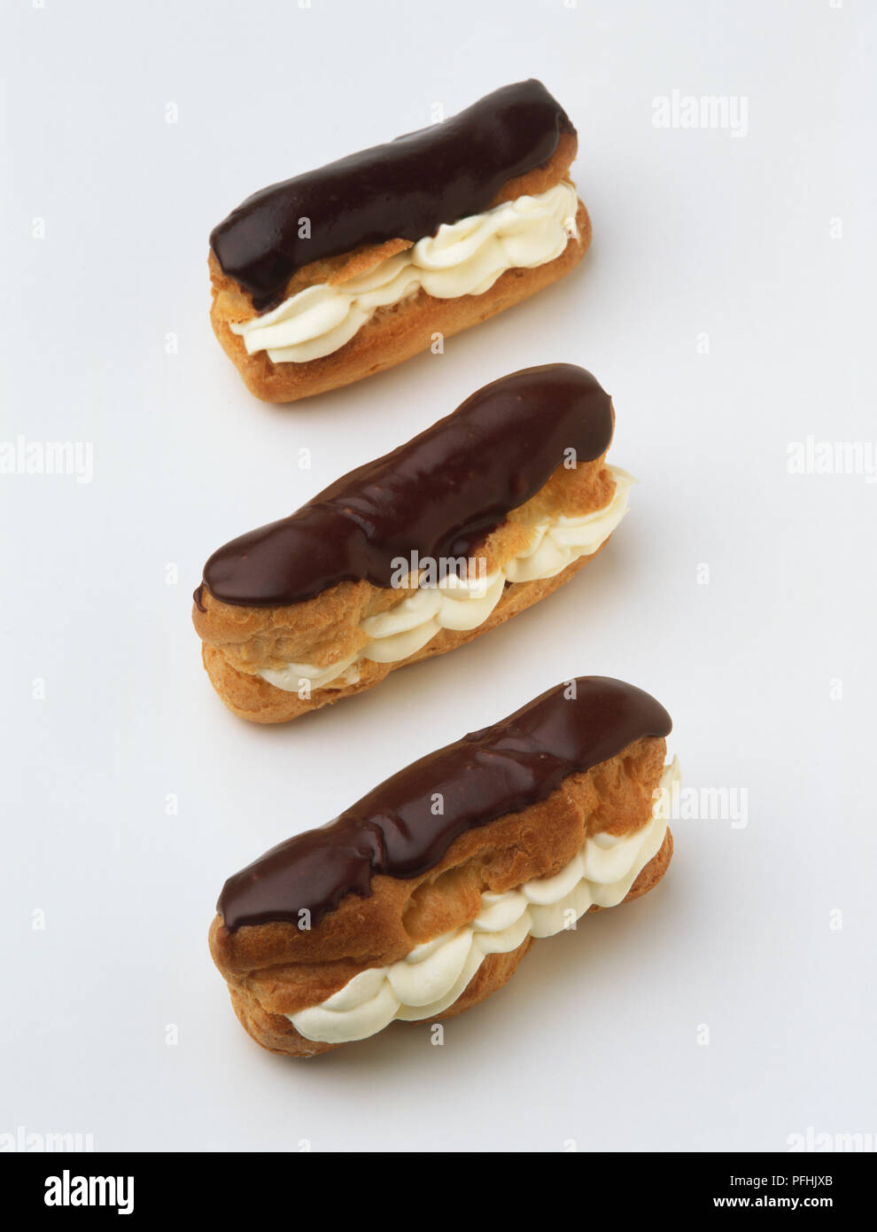 Three chocolate eclairs, close up. Stock Photo