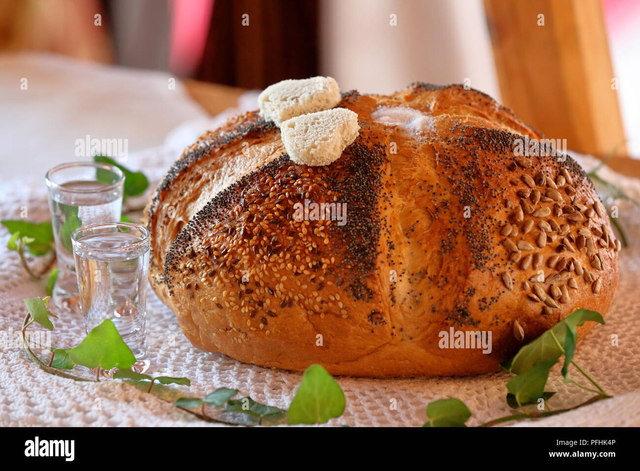 Round bread and vodka, a traditional greeting of a bride and groom Stock Photo
