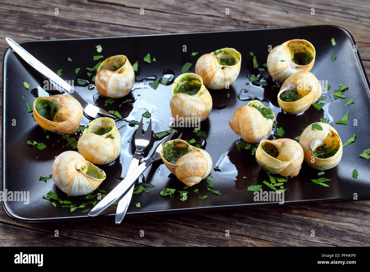 delicious gourmet dish Escargots de Bourgogne or Snails with herbs