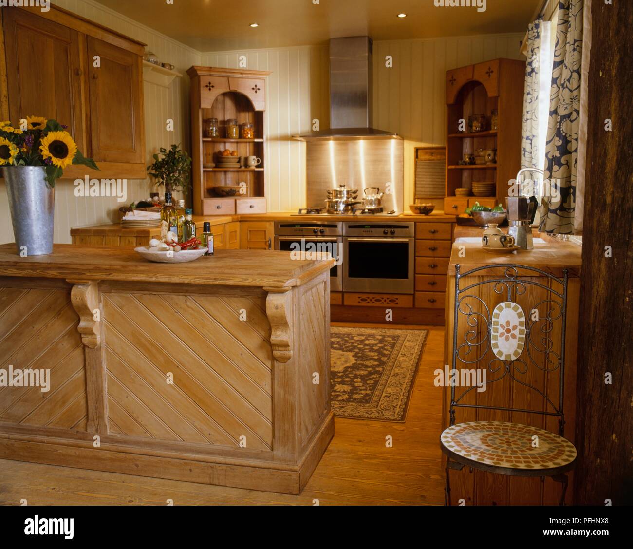 Fitted kitchen with wooden cupboards and floor Stock Photo