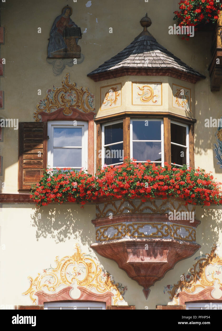 Germany, Upper Bavaria, Neubeuren, oriel window on upper facade of inn covered with colourful L?ftlmalere, a trompe-l'oeil style of house-painting. Stock Photo