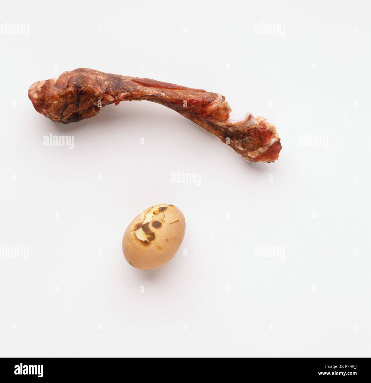 Burnt egg and and shank bone Stock Photo