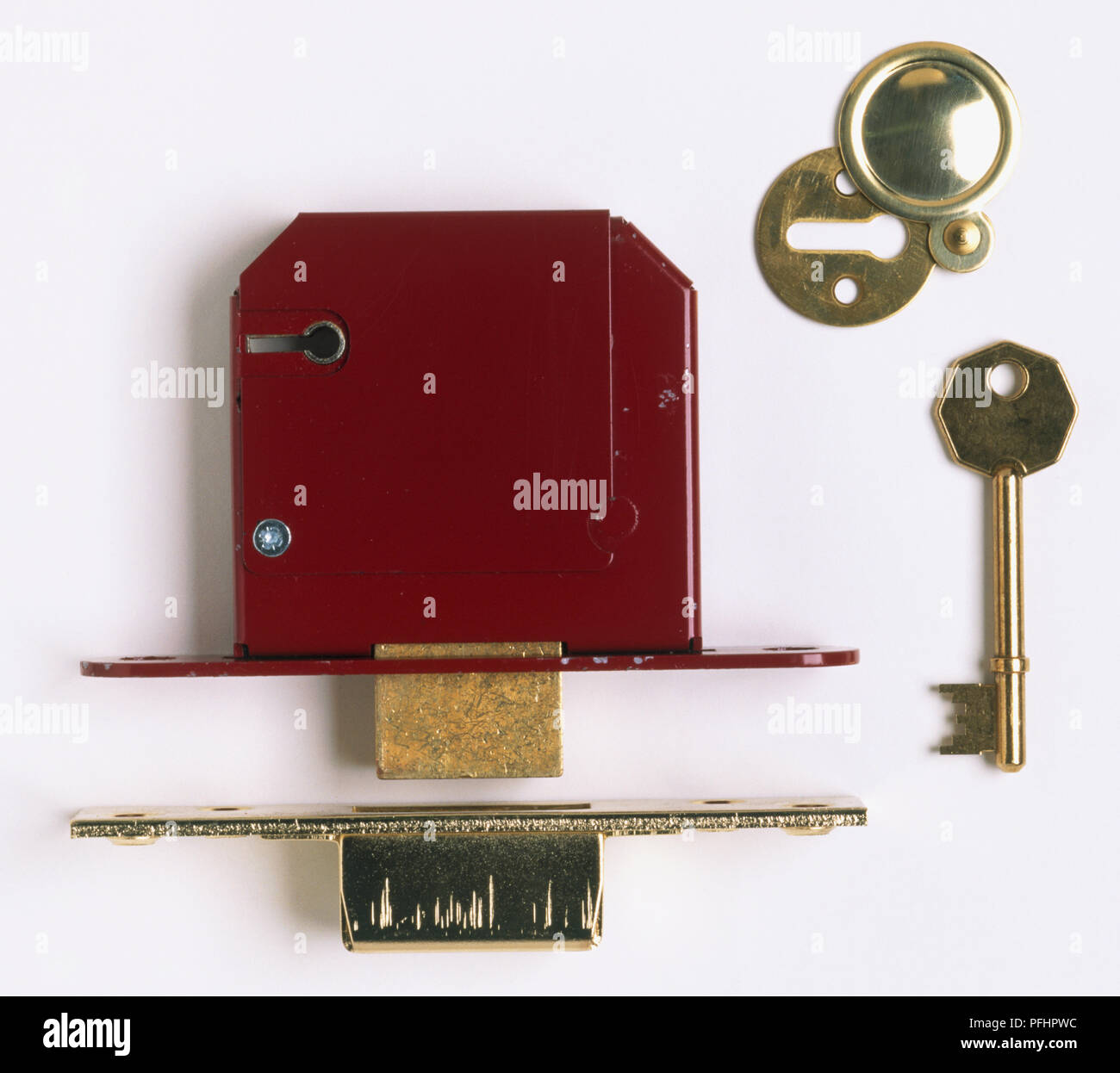 Parts of a door lock, including deadbolt, strike plate, key and keyhole frame, close up Stock Photo