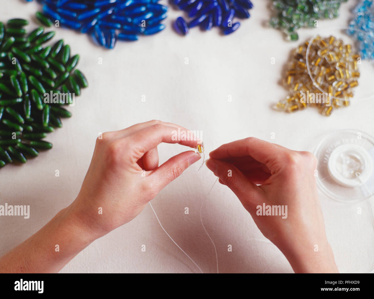 Threading a bead, piles of beads in different colours Stock Photo Alamy