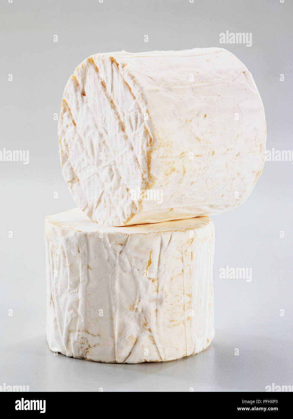 Two cylindrical blocks of camembert cheese, close up. Stock Photo