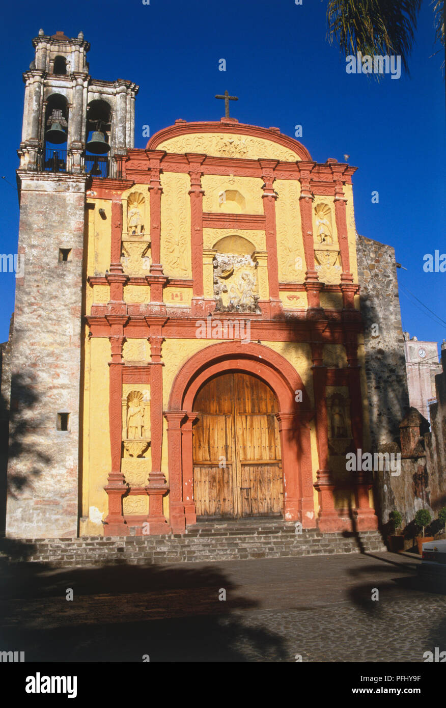 Mexico, Cuernavaca, yellow and red facade of Catedral de la Asuncion. Stock Photo
