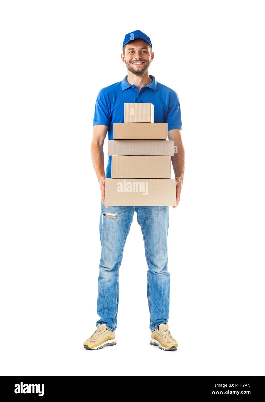 Full length portrait of confidence express courier holding pile of cardboard boxes isolated on white background Stock Photo