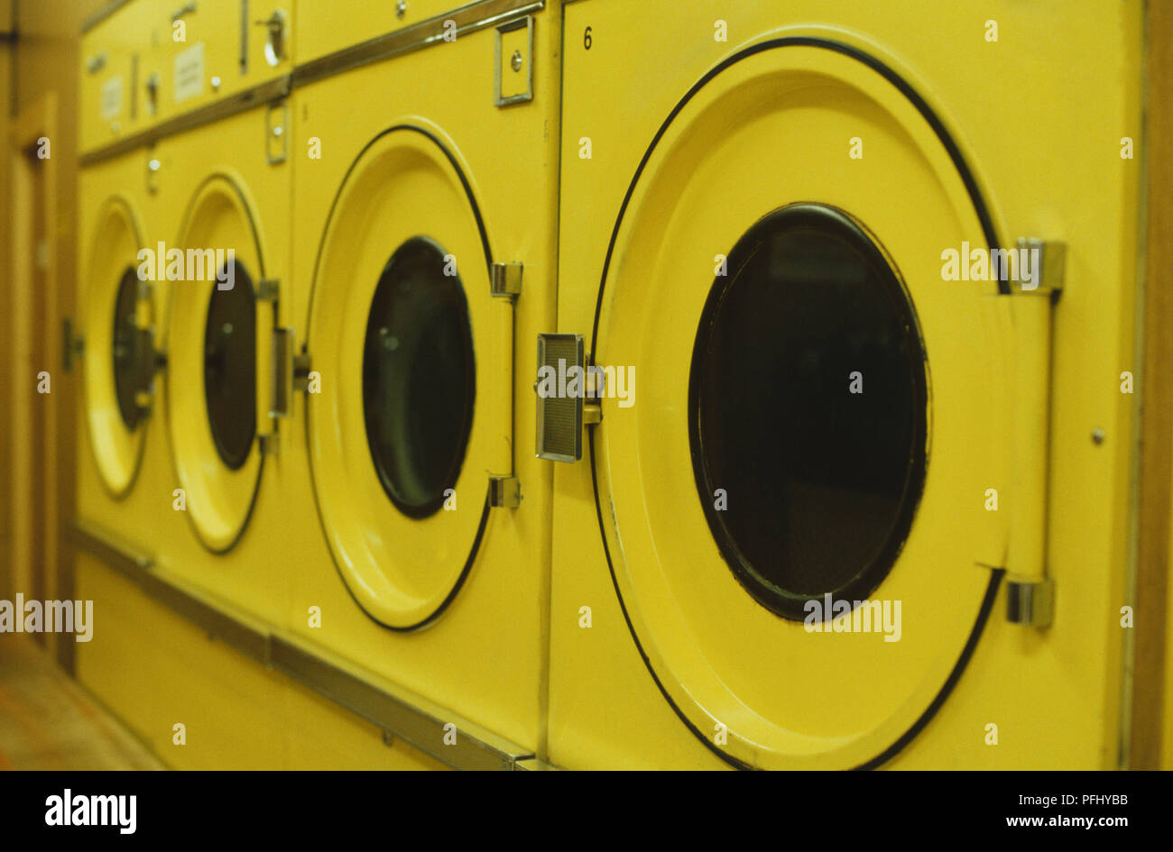 Row of washing machines in laundrette, side view Stock Photo Alamy