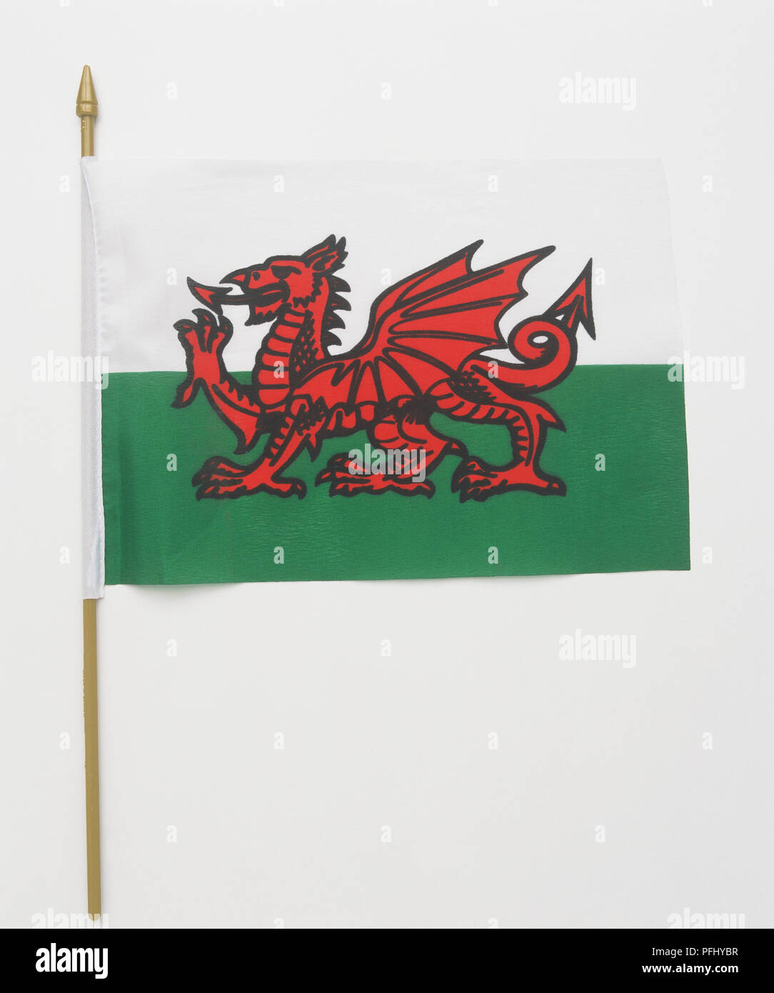 Welsh flag on gold plastic pole, front view. Stock Photo