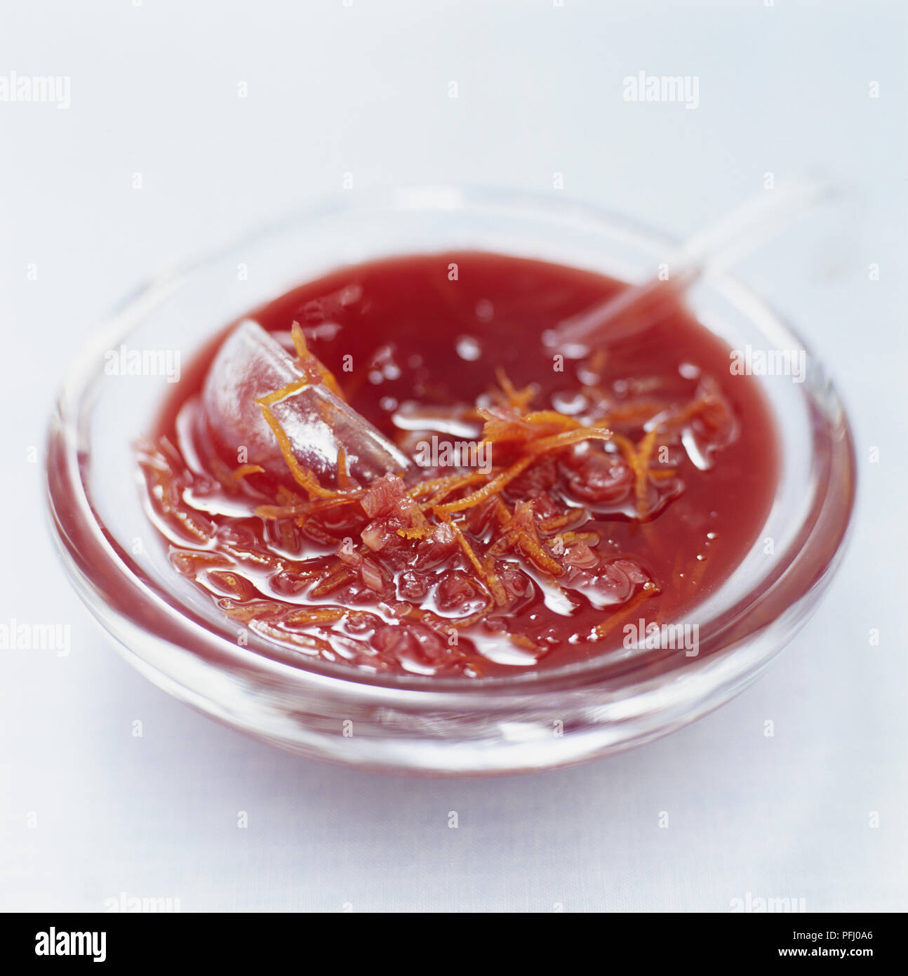 Cumberland sauce served in a glass bowl with small ladle, close up Stock Photo