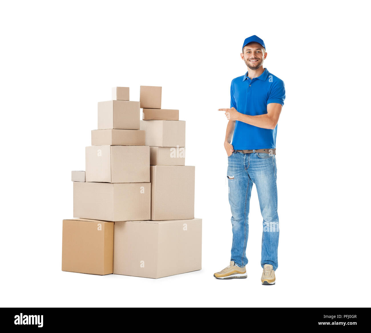 Delivery man pointing to stack of boxes isolated on white background ...