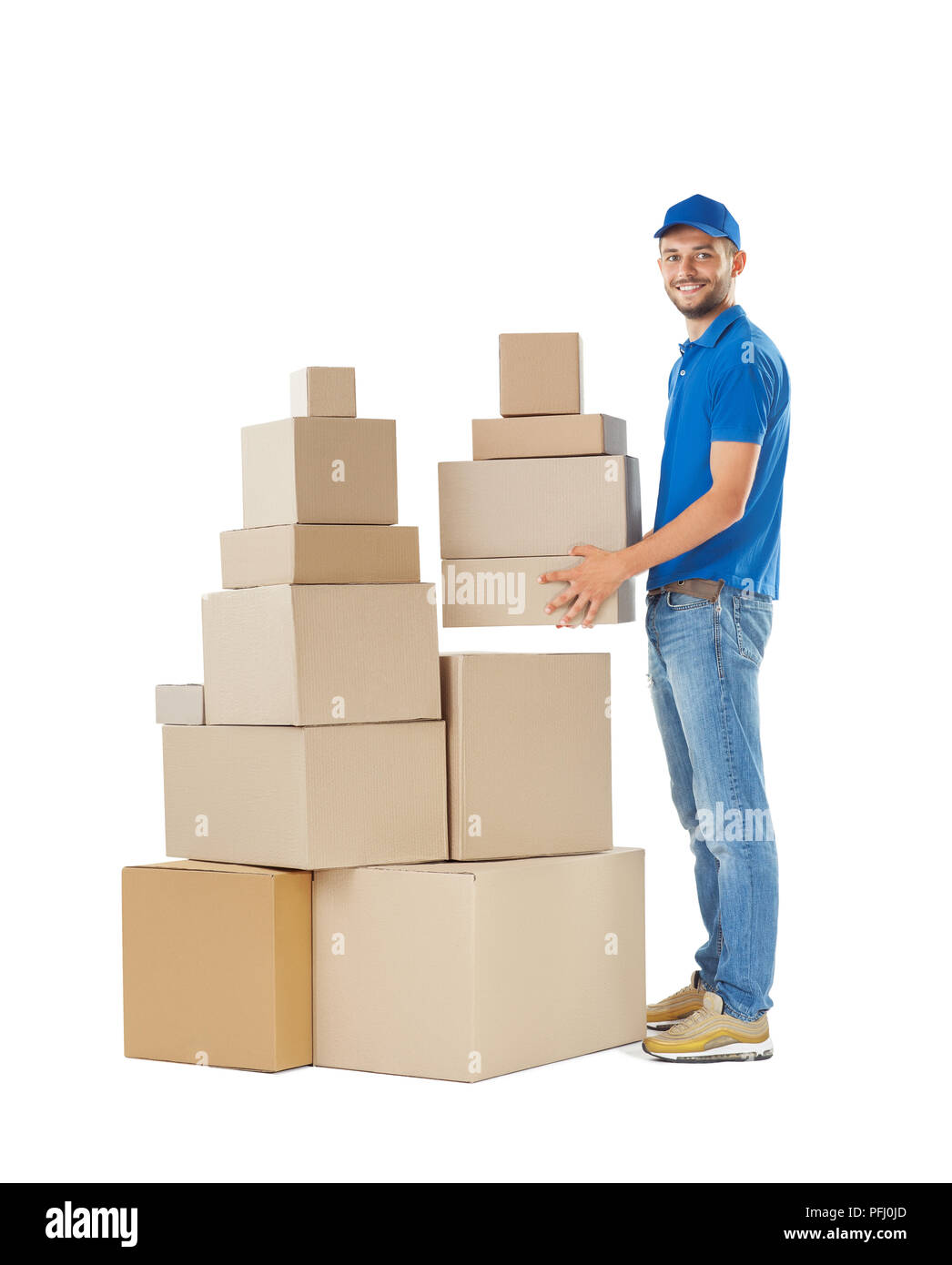 Full length portrait of delivery man holding stack of boxes isolated on ...