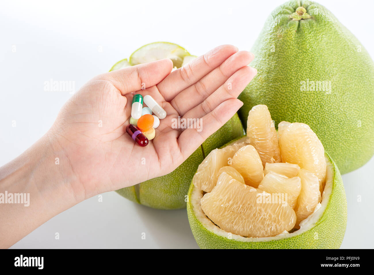 fresh and peeled pomelo(shaddock), grapefruit with drug, concept of
