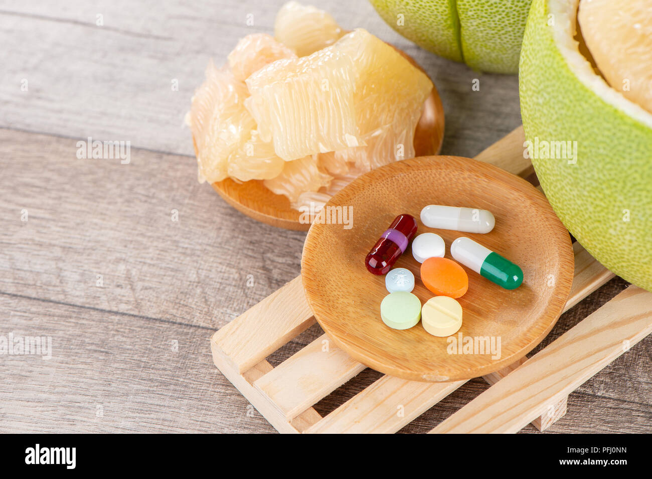 fresh and peeled pomelo(shaddock), grapefruit with drug, concept of