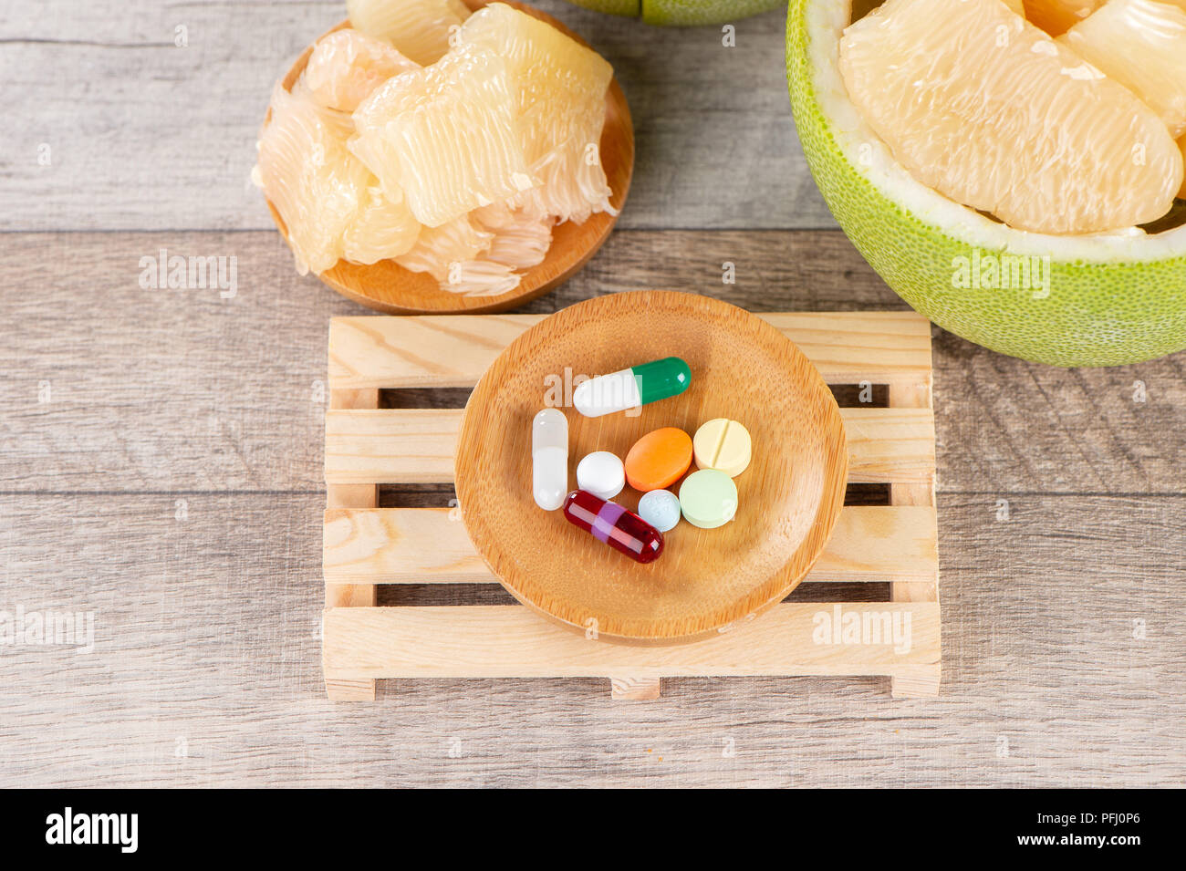 fresh and peeled pomelo(shaddock), grapefruit with drug, concept of