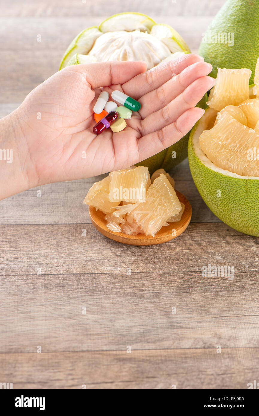 fresh and peeled pomelo(shaddock), grapefruit with drug, concept of