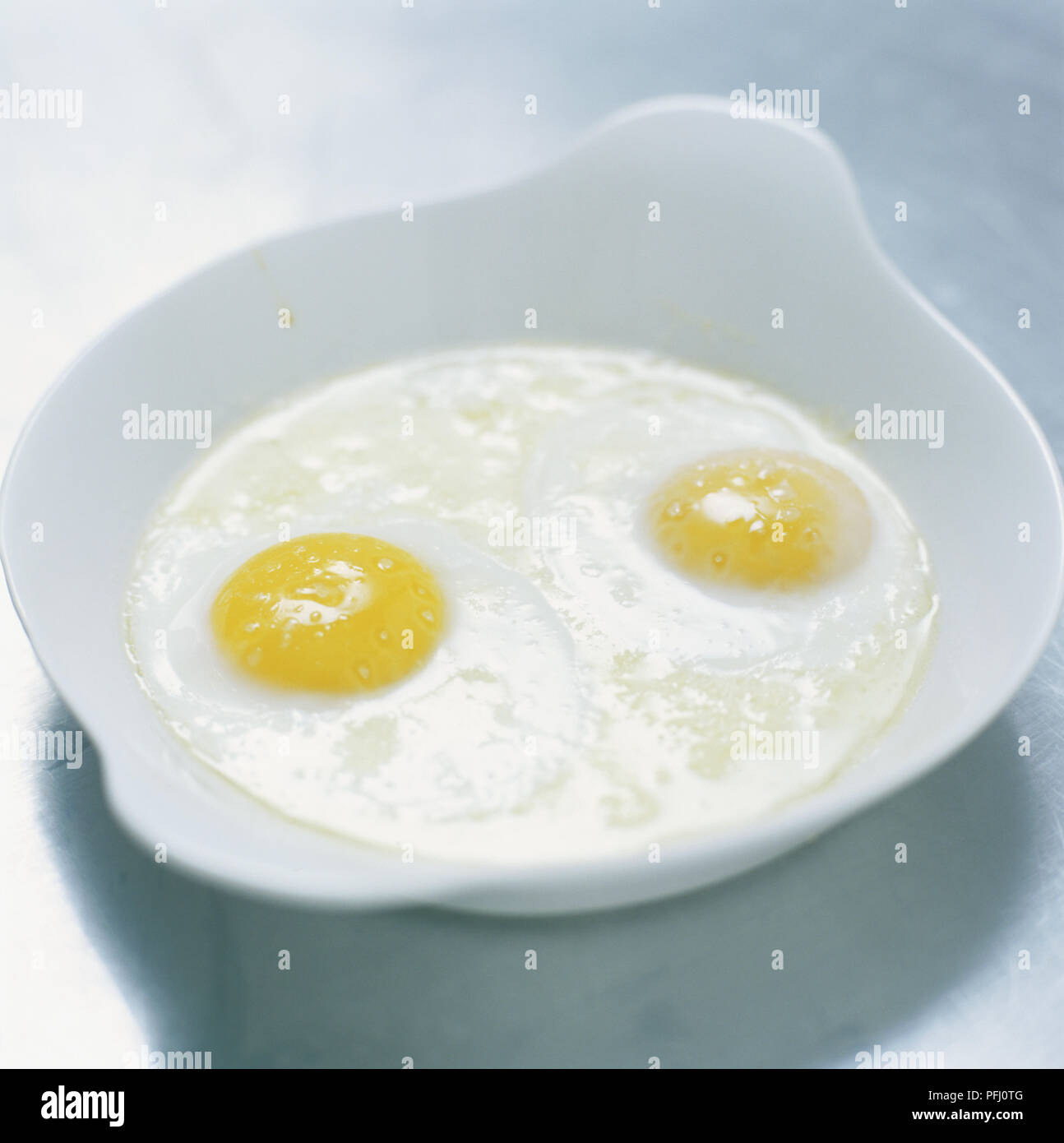 Two eggs cooked in a baking dish (sur le plat) Stock Photo