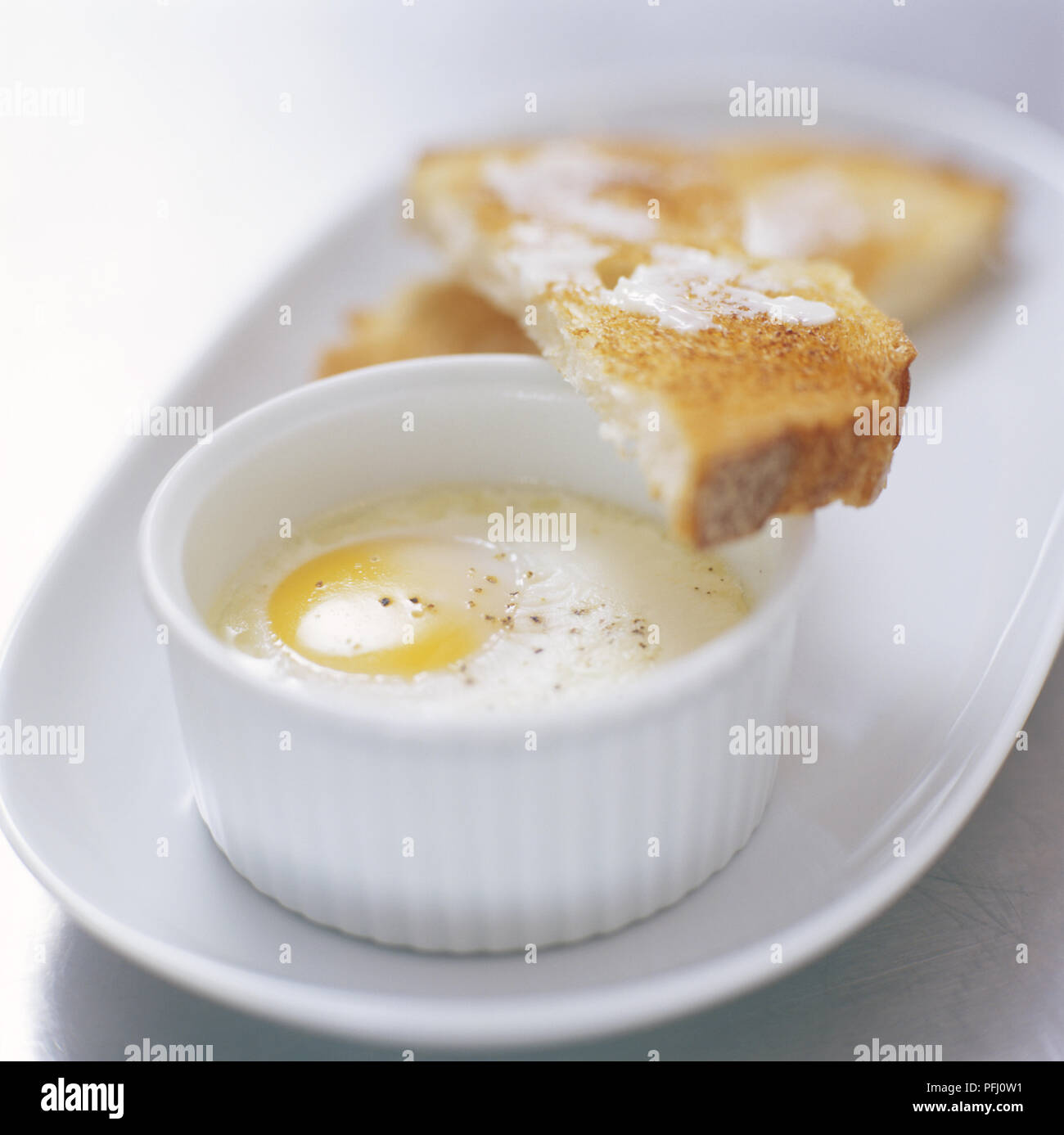 Egg cooked in ramekin (en cocotte), served with buttered toast Stock