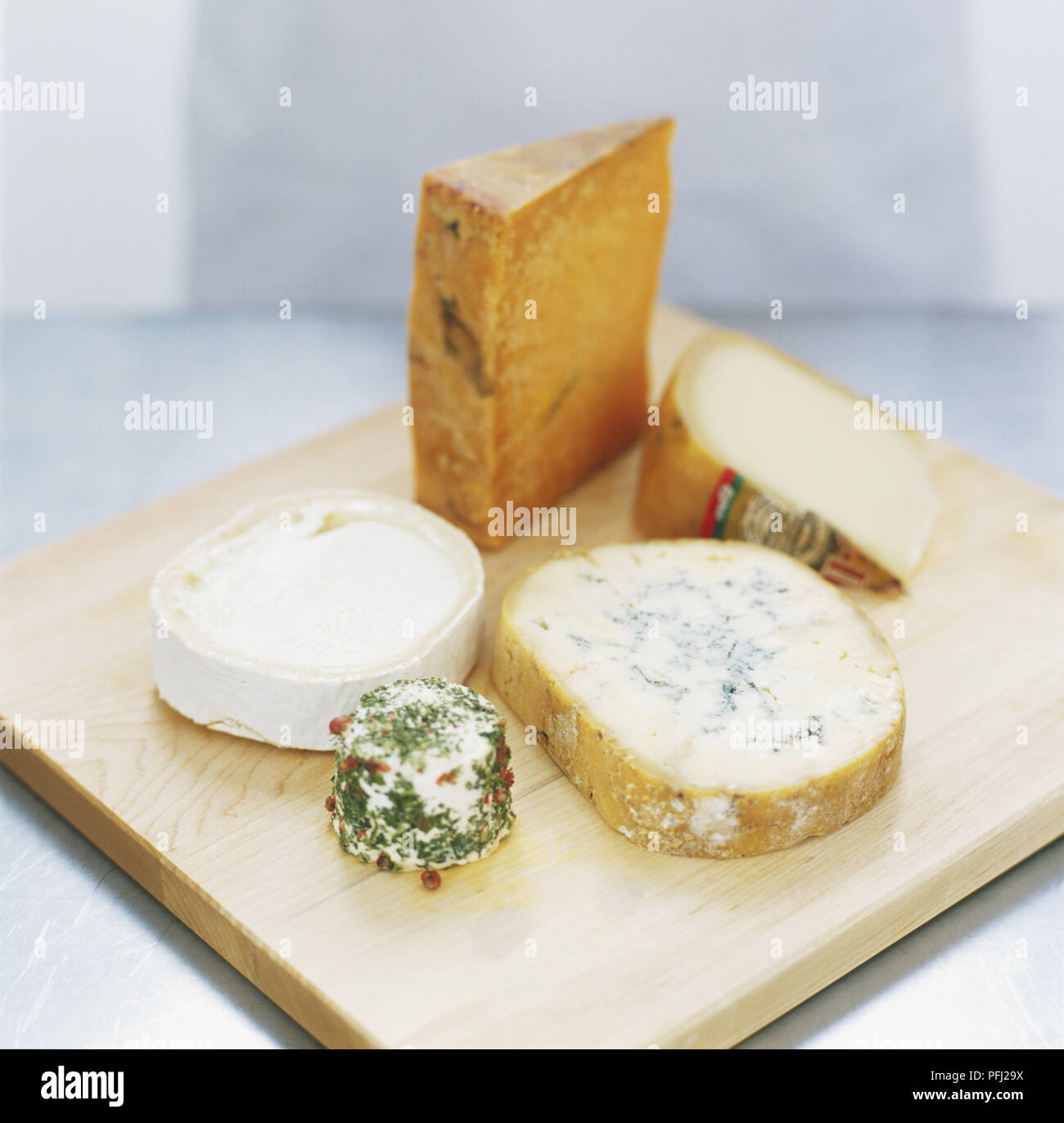 Cheese board including mature cheddar, blue cheese, goat's cheese, herb