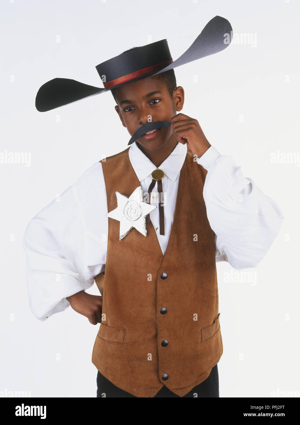 Boy wearing a sheriff's costume, including hat, waistcoat and star, waist up, front view Stock