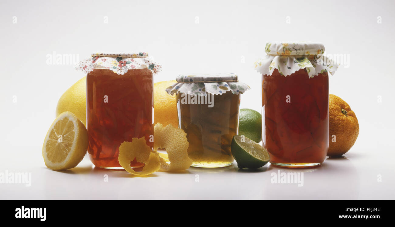 Three jars of marmalade and fresh fruit Stock Photo